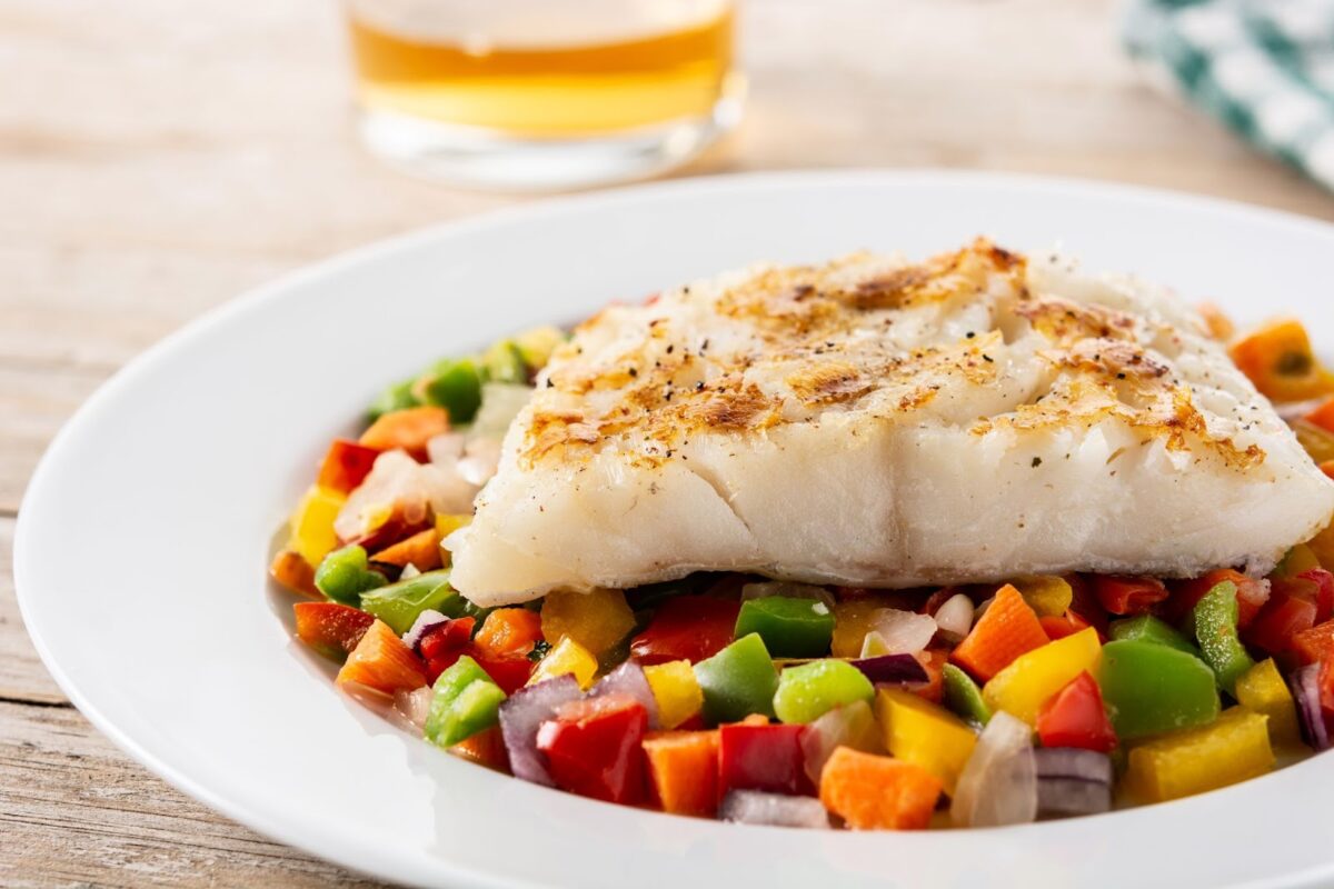 Grilled cod with vegetables on a plate