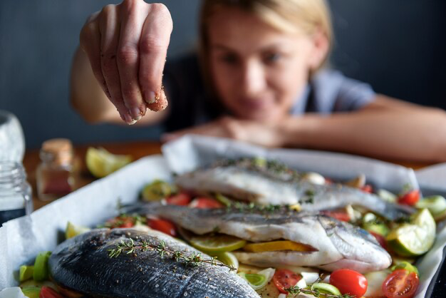 Girl cooking fish