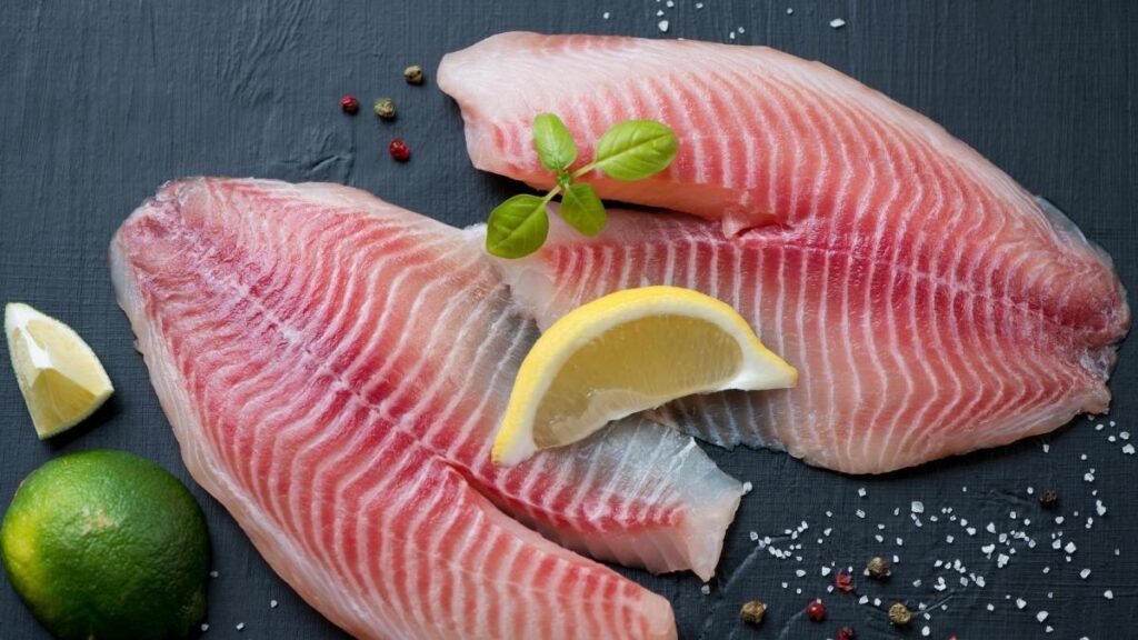 Tilapia fillet with a slice of lemon and lime